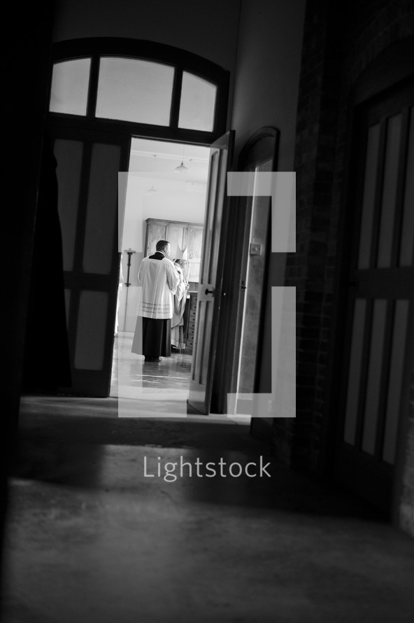 priest through a door 