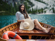 a young woman on a rowboat on vacation relaxing 