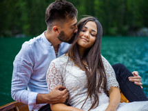 a couple cuddling on a rowboat 