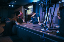 kneeling over a stage during a worship service