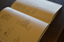 notes in a journal on a table 