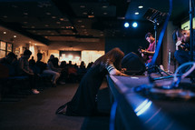 kneeling over a stage during a worship service 