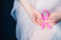 Woman holding pink breast cancer ribbon