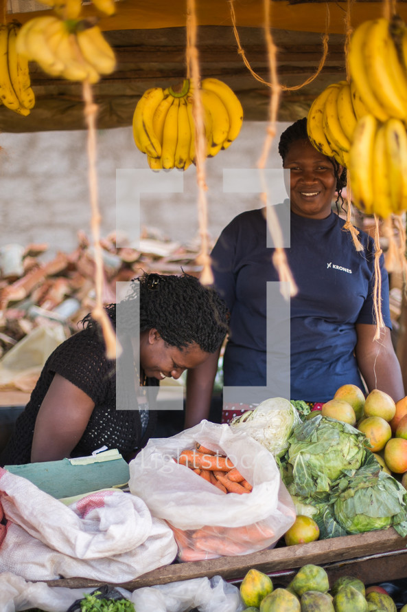 hanging bananas and a smiling vendor 