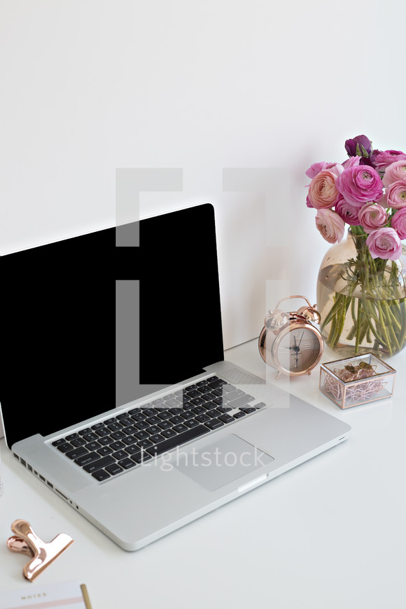 roses in a vase and laptop computer 