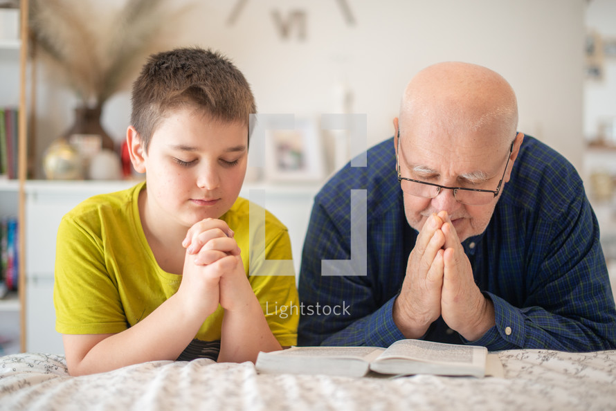 father and teen son praying together 