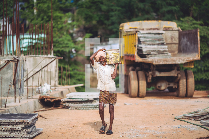 man in India carrying water 