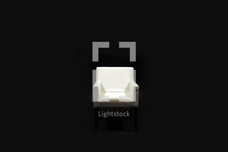 isolated white chair in a black background 