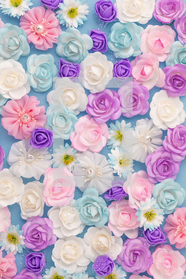 Bed of white pink and blue Flowers flay layer background