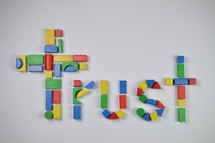 cross and word trust of colorful toy wooden blocks 