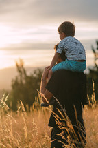 Father and son looking at the sunset