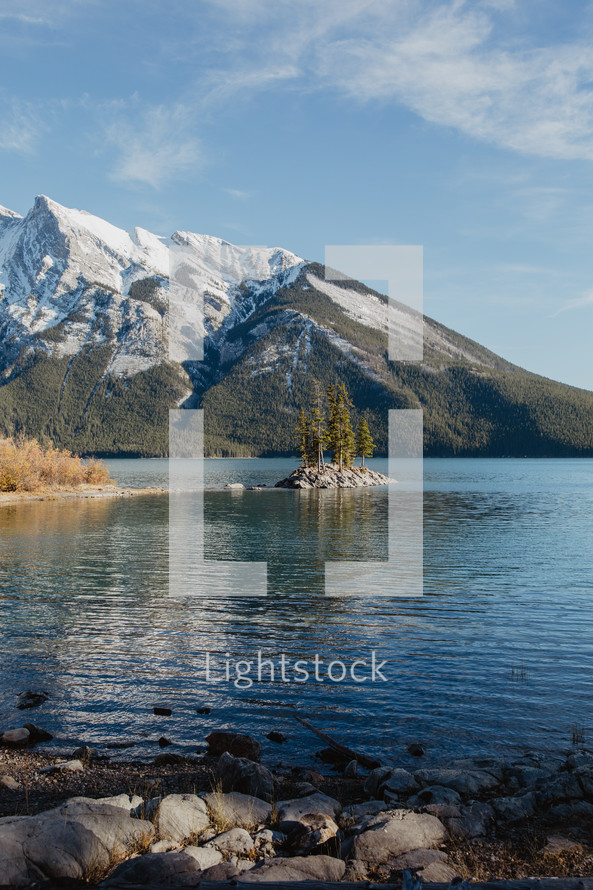 lake, snow capped mountains and evergreen forest 