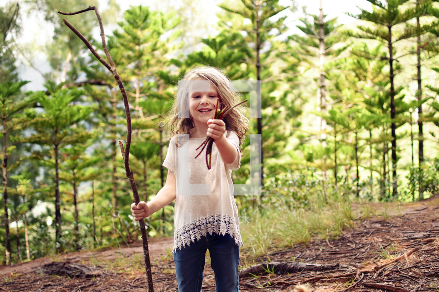 a little girl exploring a forest 