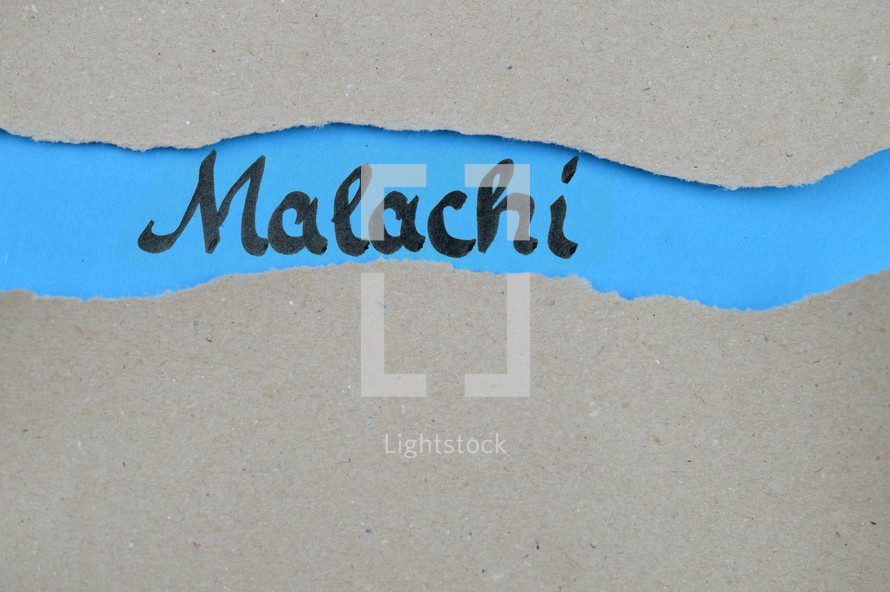 Malachi - torn open kraft paper over blue paper with the name of the prophetic book Malachi
