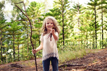 a little girl exploring a forest 