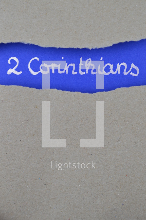 2 Corinthians - torn open kraft paper over intense blue paper with the name of the second letter from Paul to the Corinthians