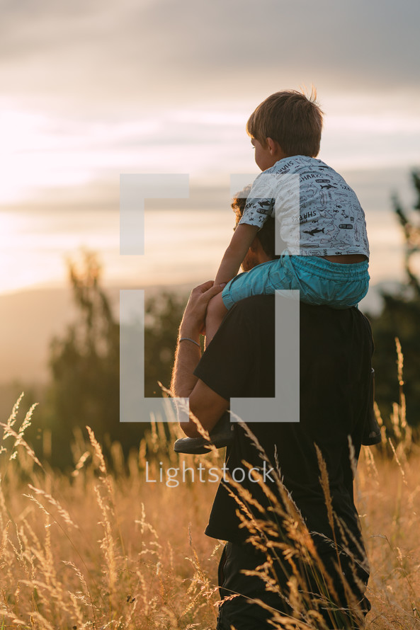 Father and son looking at the sunset