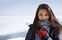 a young woman standing in a snow covered landscape 