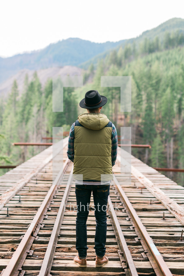 a man standing on a train bridge 