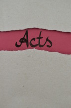 Acts - torn open kraft paper over dark red paper with the name of the book of Acts