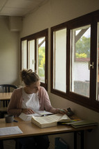 Woman reading and studying in front of a window