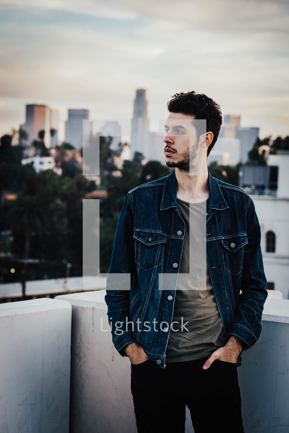 a man with a city view behind him 