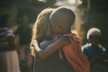 missionary hugging a young child in Kenya 