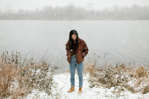 a woman standing in falling snow 