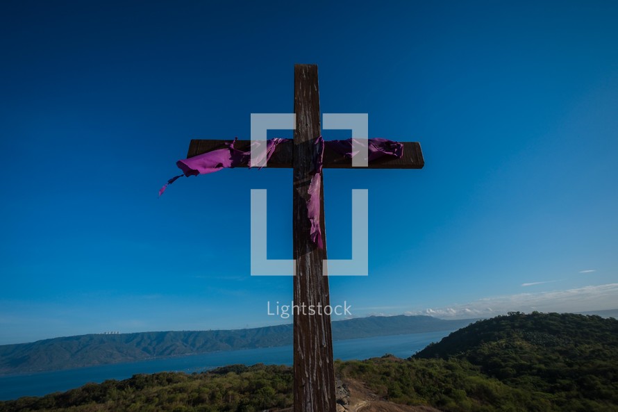 purple shroud on a wooden cross 