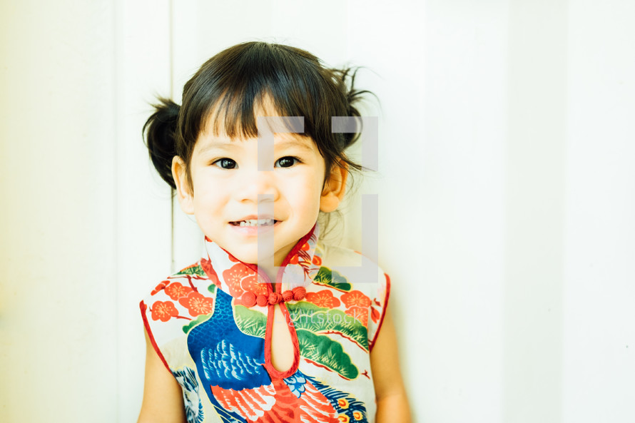 smiling little girl in a traditional Chinese dress 