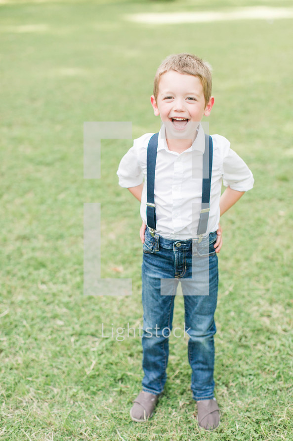 a happy boy child in suspenders 