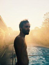 man standing in front of a pool 