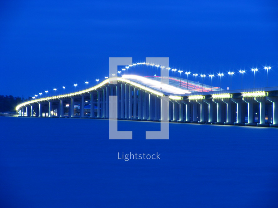 outline of a lighted bridge at night