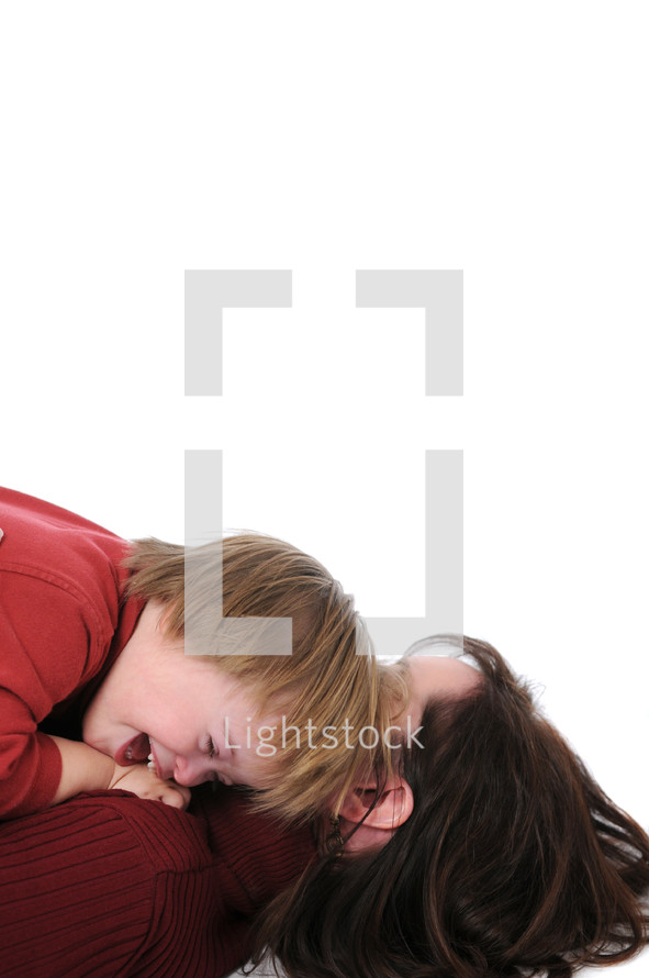 mother and son hugging on the ground 