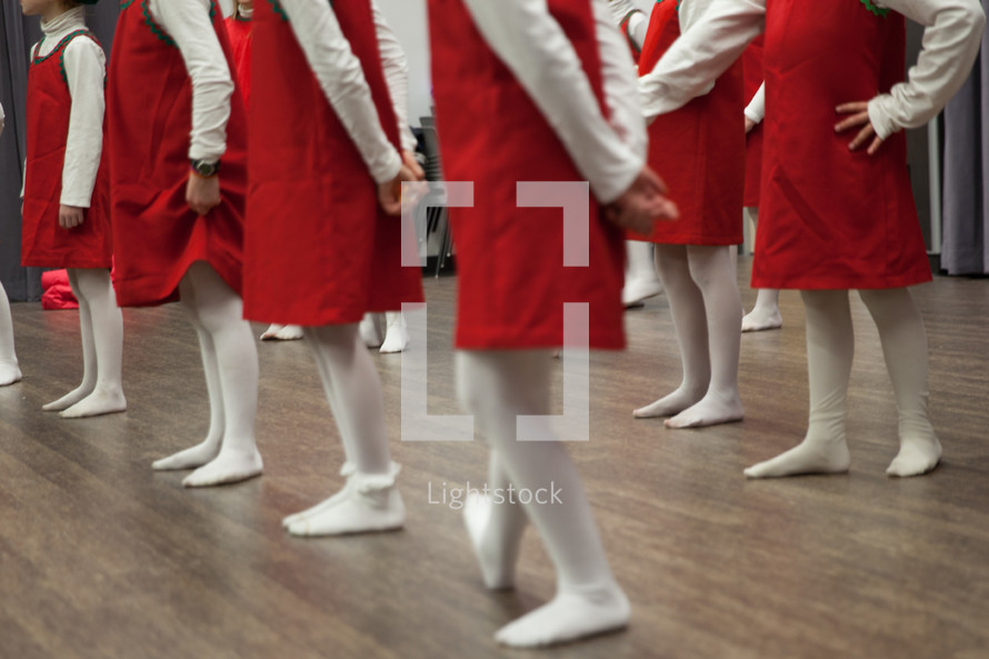girls in red dresses and white tights for a holiday program 