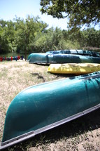 Canoes on the banks of a river.