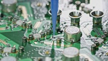 Close up of glue application on a large circuit board