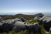Rocks on the top of a coastal mountain top (Robben Island in the background)