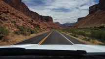 Driving POV through a scenic red rock canyon in the American southwest