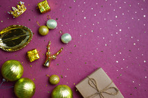 Christmas gift theme with golden ornaments over the red background. 