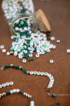 Jar of green, white, and gold beads with word - thoughtful