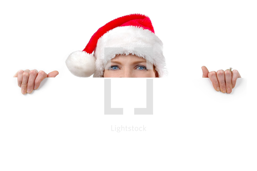 woman in a santa hat peeking 