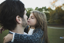 a man kissing his daughter 