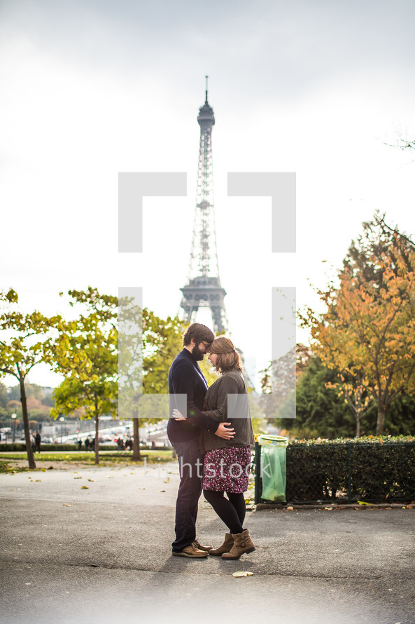 a couple standing in front of the Eiffel Tower 