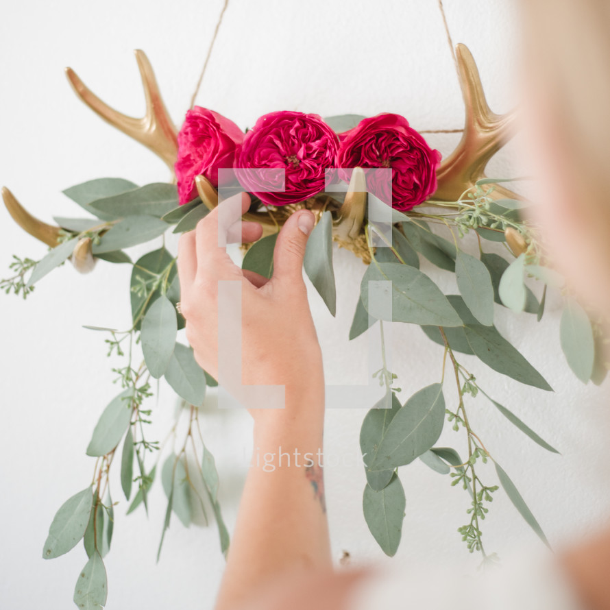antlers holding flowers and eucalyptus 