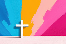 'Minimalist white cross set against a vibrant, colorful background with bold brush strokes. A modern representation of Christian faith and spirituality.