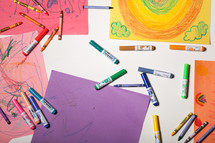 children's artwork displayed across a table 