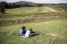 Little girls creating playing on a hill in the fall