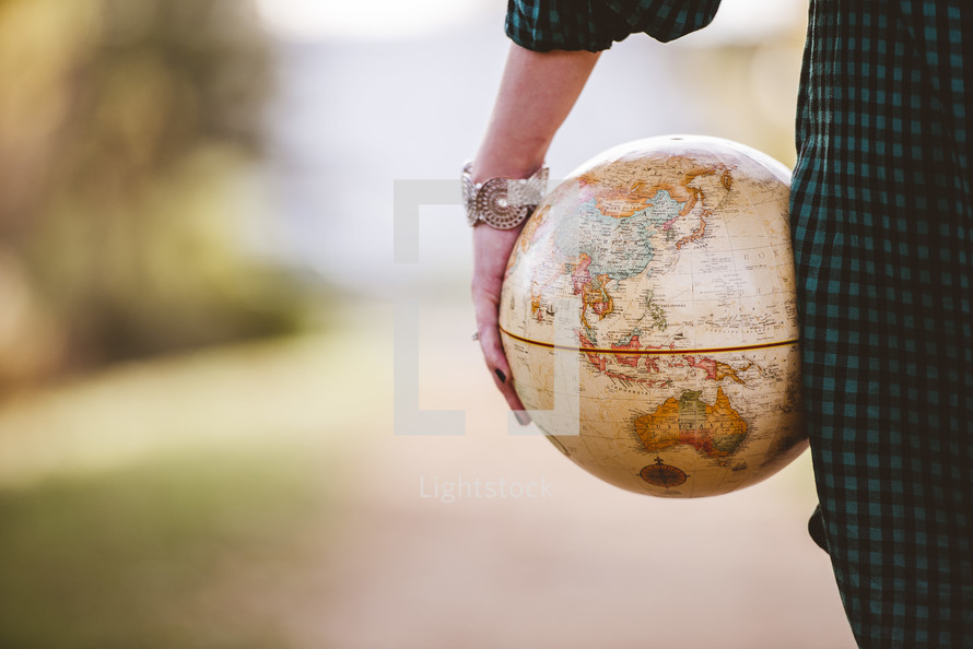 a woman holding a globe 