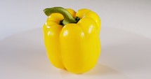 close up a yellow bell pepper rotating on a white background